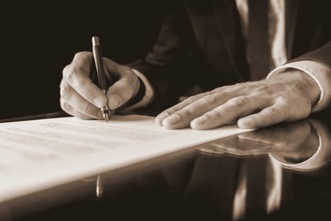 signing paperwork for scottish legal system header